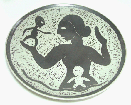 An undated plate by Mary and Edwin Scheier was decorated with a figure within a female figure.