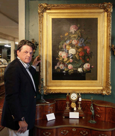 Auctioneer Kaja Veilleux stands with the oil on canvas still life painting by Severin Roesen (1815‱872) that brought $57,500.