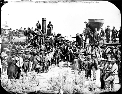 Andrew Joseph Russell's 1869 ambrotype "East and West Shaking Hands at Laying of the Last Rail†depicts the completion of the East/West corridor with railroad and state officials shaking hands and raising a champagne bottle as the workers who built the line gather around.