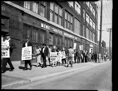 Charles "Teenie†Harris, "Protesters with UNPC signs outside United Mine Safety Appliance Company, Braddock Avenue, Homewood,†October 1963. Teenie Harris Archive ©Carnegie Museum of Art.