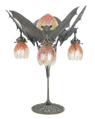 Fetching $13,035 was this Austrian Art Nouveau bronze table lamp from the early Twentieth Century. It has three outstretched bats holding Loetz-type art glass drop shades from their teeth, all centering on three smaller bats below a center teardrop shade, 27 inches high.