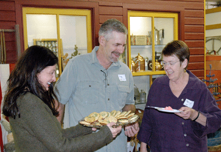Betty Berdan, left, and Cheryl Mackley, flank Greg Mummert, owner of Antiques at Ivy Hall. ⁒. Scudder Smith photos.