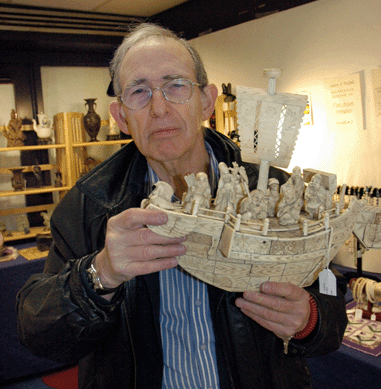 James Dolph, owner of JSD Antiques, Durham, N.H., holds a Japanese Meiji period Treasure Boat with Seven Happy Gods, an ivory sculpture made circa 1890