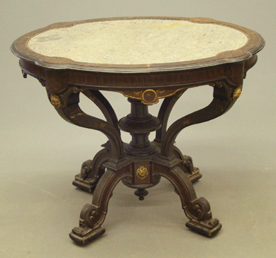 A Nineteenth Century Renaissance Revival marble top incised and inlaid center table, 37 by 33 by 29 inches, realized $3,738.
