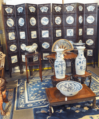 A nice Chinese eight-panel hardwood screen with blue and white porcelain plaques depicting landscapes more than doubled estimates at $18,000. The Nineteenth Century Chinese Export carved hardwood table with marble top brought $12,000.