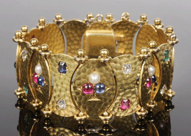 The Faberge gold bracelet set with diamonds, rubies, emeralds and sapphires realized $17,250.