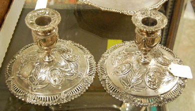 A pair of early English coin silver candlesticks realized $633.