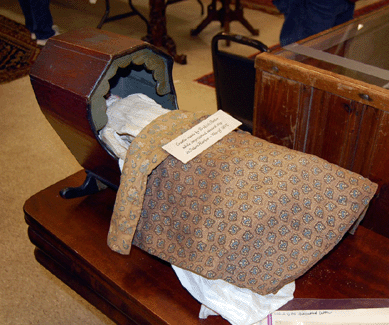 An early Nineteenth Century sailor-made cradle and a doll with a porcelain headed doll sold for $546. 