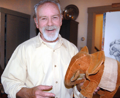 The artist-collector is pictured with a prized chunky velvet elephant, late Nineteenth or early Twentieth Century.