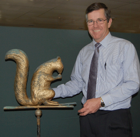 Paul McInnis shows off the sale's top lot, this squirrel weathervane by L.W. Cushing and Sons of Waltham, Mass., which brought $55,575.