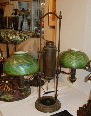 Both damascene glass shades of the bronze student lamp were marked "LCT.†The lamp realized $7,703.