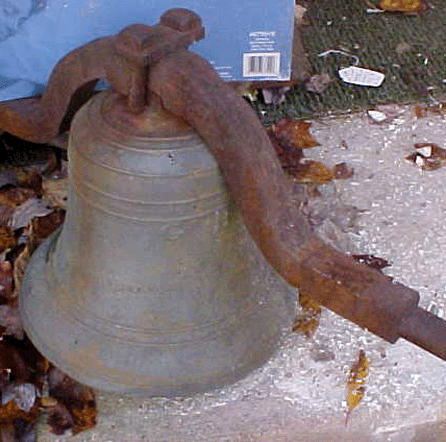 The 12-inch-diameter bronze church bell, circa 1835, with identifying mark "GH†stamped on its side.