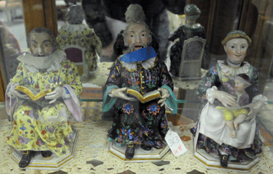 A Meissen figure of a bearded man reading a book with nodding head, left, realized $2,185, while the pair of Meissen figures with nodding heads depicting a preacher and his wife brought $7,475.