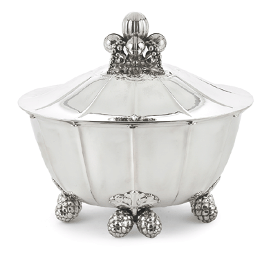 A Danish sterling silver covered soup tureen, Georg Jensen Silversmithy, Copenhagen, #340, 1945‱977, nearly doubled its high estimate to realize $74,500. The lid has a grape cluster and curled leaf finial and the body is raised on double pinecone and leaf feet, total weight about 117 troy ounces.