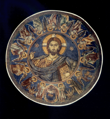 In the restored dome fresco, Christ is in the center, surrounded by angels. Although not symmetrical, the imperfections of the artist working in a rustic chapel add to the vibrancy of the portrait.