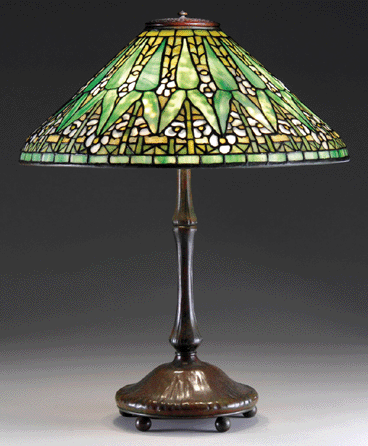 A Tiffany Studios Arrowroot table lamp with its conical shade was decorated in flowers in various stages of bloom. It sold at $51,750.