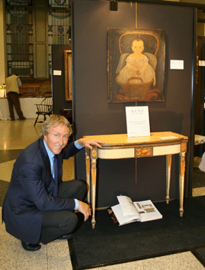 Auctioneer Leigh Keno with the Salem, Mass., card table, $347,200 ($50/100,000), that is attributed to Boston's foremost Federal cabinetmaker, Thomas Seymour.  The painted decoration is thought to be by Joshua Holden working in the John Ritto Penniman shop. The table is from a suite of furniture that includes four chairs, one at Winterthur and one on loan to the New York State Museum. Inscribed "Eleanor Maria Doane 1841,†the Hamblin-Prior school portrait soared to $142,600 ($25/35,000).