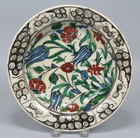 This Fifteenth or Sixteenth Century Isnik earthenware dish with a bold pattern of red, green and blue flowers sold for $2,925 on the phone, but was stolen from the pickup area before the sale ended.