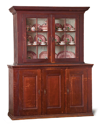 A New Bremen, Auglaize County, Ohio, walnut stepback cupboard had a great provenance; the original aqua glass in the upper doors and its original finish propelled the cupboard to $29,735.