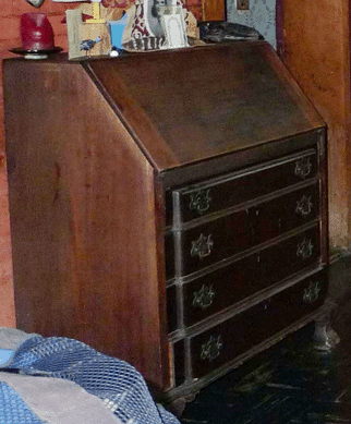 Slant top desk, late Nineteenth or early Twentieth Century, with several small drawers and carved details. 