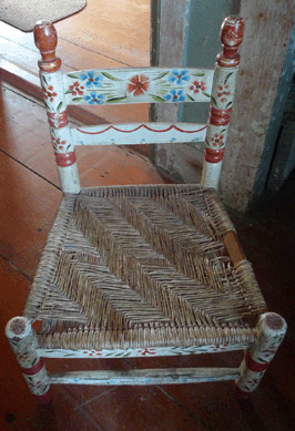 Hand painted, caned child's chair, with  gap in the right side of the caning.