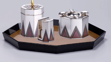 A smoking set constructed of lacquered wood, silver and red bronze, circa 1930, by Kawachi Somei.
