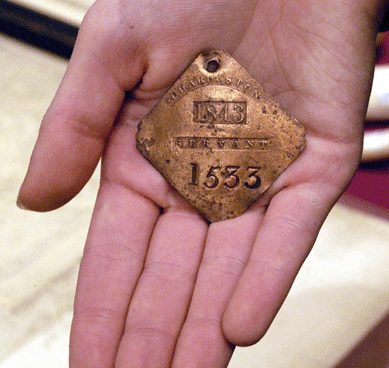 A slave tag from 1843, indicating the slave's occupation, as offered at Adrian Morris Antiques, East Aurora, N.Y.