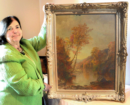 Mid-Hudson auctioneer Joanne Grant with the Jasper Cropsey painting that sold for $180,000. The painting, depicting Greenwood Lake, sold to private collectors from Pennsylvania who bought the painting as a "celebratory present †a birthday present to themselves.†
