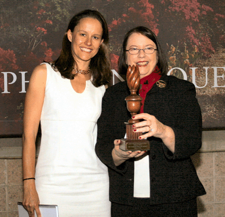 Tracy S. Whitehead, right, president of the American Folk Art Society, accepted the trophy, a carved finial, from ADA President Judith Livingston Loto. The American Folk Art Society is the winner of the 2012 Award of Merit, presented annually by the Antiques Dealers' Association of America.