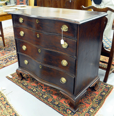 The cherry Chippendale oxbow chest of drawers sold at $4,370.