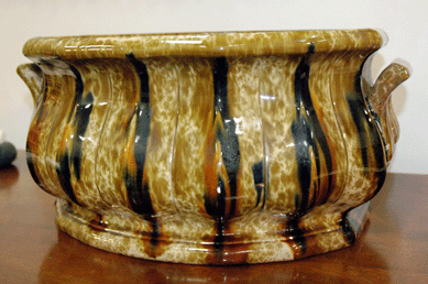 This rare Bennington flint enamel footbath with scalloped rib, circa 1848‴9, 14 by 20 inches, was a highlight in the booth of Charles and Barbara Adams, South Yarmouth, Mass.