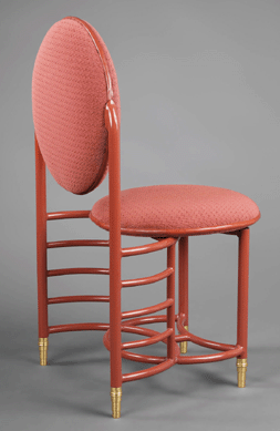 Frank Lloyd Wright designed the Racine, Wis., headquarters of the Johnson Wax Company. Part of the assignment was the design of office chairs. Early examples were three legged. The example on view, in Cherokee red enameled steel, has four legs. The chairs were made by Steelcase of Grand Rapids, Mich.