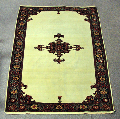 A Fereghan Sarouk center medallion Oriental run, 6 feet 6 inches by 4 feet 6 inches, realized $8,968.