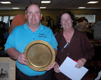 Michael Coyle and his sister, Nancy Wyman, pause for a photograph before their May 15 sale. Michael holds the Tiffany charger that sold for $575.