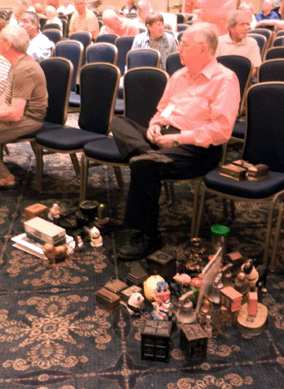 It appears, judging from two piles of banks on the floor, that this gentleman seldom lowered his paddle during the still bank auction.