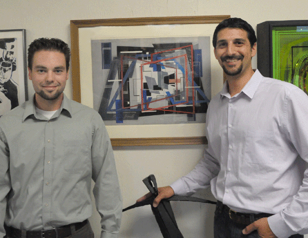 Black Rock Galleries auction house principals Travis Worrell and Grant Panavese with the Irene Rice Pereira painting that sold for $12,925. 