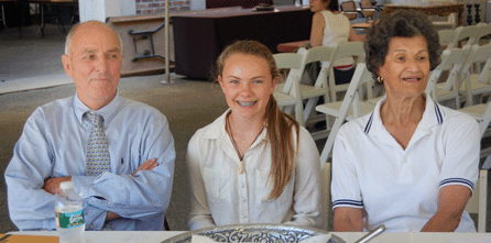 Mike Corcoran is pictured with his 12-year-old niece, Jane Leys, who was working her first auction. Corcoran's stalwart staffer, Elsie Lombard, who has been managing auctions in Newport since 1952, is to the right.