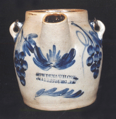 Profuse with cobalt decoration and depicting a bird holding a flower on one side and a double bunch of grapes on the spout side, this circa 1865 stoneware batter pail piece stamped "Cowden & Wilcox / Harrisburg, Pa.,†brought $14,950 from a New York collector on the phone.