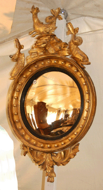A Federal giltwood convex mirror with a carved hippocampus crest went for $2,880.