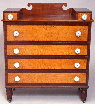 A late Federal Vermont six-drawer chest, circa 1820‱830, of bird's-eye maple with walnut veneer, exhibits development of the form: the uppermost long drawer is deeper than the three below, perhaps to hold bonnets, and two small glove drawers have been added to the top surface.