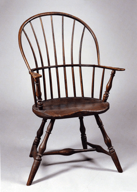 Early into the sale this red painted. sack back Windsor armchair, probably Boston, 1790‱800, with seven spindles which fan outwards, 40½ inches high, sold for $16,590.