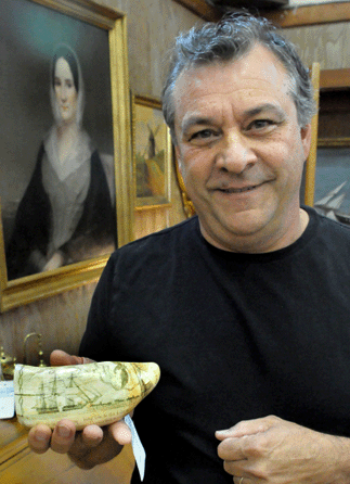 Auctioneer Rafael Osona with the rare Susan's tooth by Frederick Myrick that sold for $139,200.