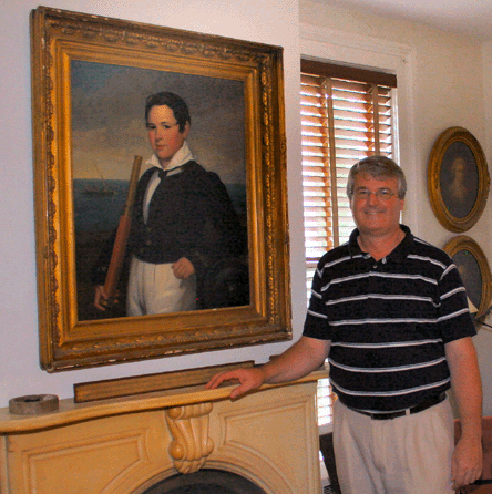 Paul Russ with the sale's top lot, a portrait believed to depict Charles Henry Mallory (1818‱890) as a young boy. After working in the New York office of his father's diversified shipping business, Mallory in 1866 established C.H. Mallory & Co with another Mystic man, Elihu Spicer (1825‱893). The painting sold in the room to antiques dealer Glenn Randall for $49,450. Russ Antiques & Auctions attributed the work to the New London, Conn., painter Isaac Sheffield (1798‱845).