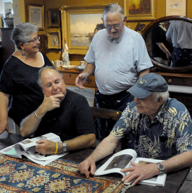 Auctioneer Bob Eldred chats with clients prior to the auction.