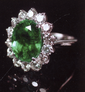 This lady's 18K white gold ring, classic princess style set with a large oval shape natural emerald in the center, like new condition, brought $34,500.