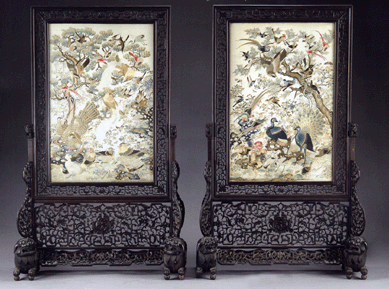 A rare and fine pair of carved hardwood Chinese framed embroideries, circa 1870, China, the frames with foo dog feet enclosing panels of the 100 birds. The overall size is 74 inches high, 46½ inches wide and 20 inches deep and the embroidery measures 32½ by 29 inches. Estimate at $20/30,000, the pair realized $86,250.