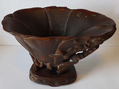 A Seventeenth or Eighteenth Century rhinoceros horn libation cup was carved in the form of a lotus and sold for $17,550.