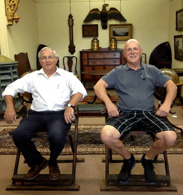 Arthur Liverant, left, and Carl Nordblom take their leisure in a pair of Eighteenth or Nineteenth Century huanghuali folding armchairs with horseshoe backs and woven twine seats that brought $3,218. The folding footstools, also with woven twine, had been fitted with hardwood tops to create tables (which were subsequently removed) and sold for $1,170.