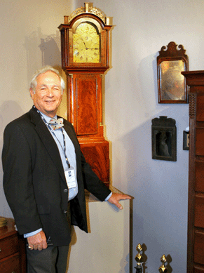 John Bailey II (active 1770‱820) of New Bedford, Mass., made this dwarf clock housed in a mahogany case in the last quarter of the Eighteenth Century. Colchester, Conn., dealer Arthur Liverant offered the timepiece, a highlight of his display, for $95,000.