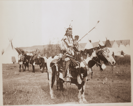 This photograph taken in Montana shows Spotted Rabbit Apsaalooke (Crow) astride his mount around 1905. The horse, along with the rider, is festooned in full war regalia. This fierce warrior was killed while raiding a cavalry outpost. ⁆red E. Miller photo